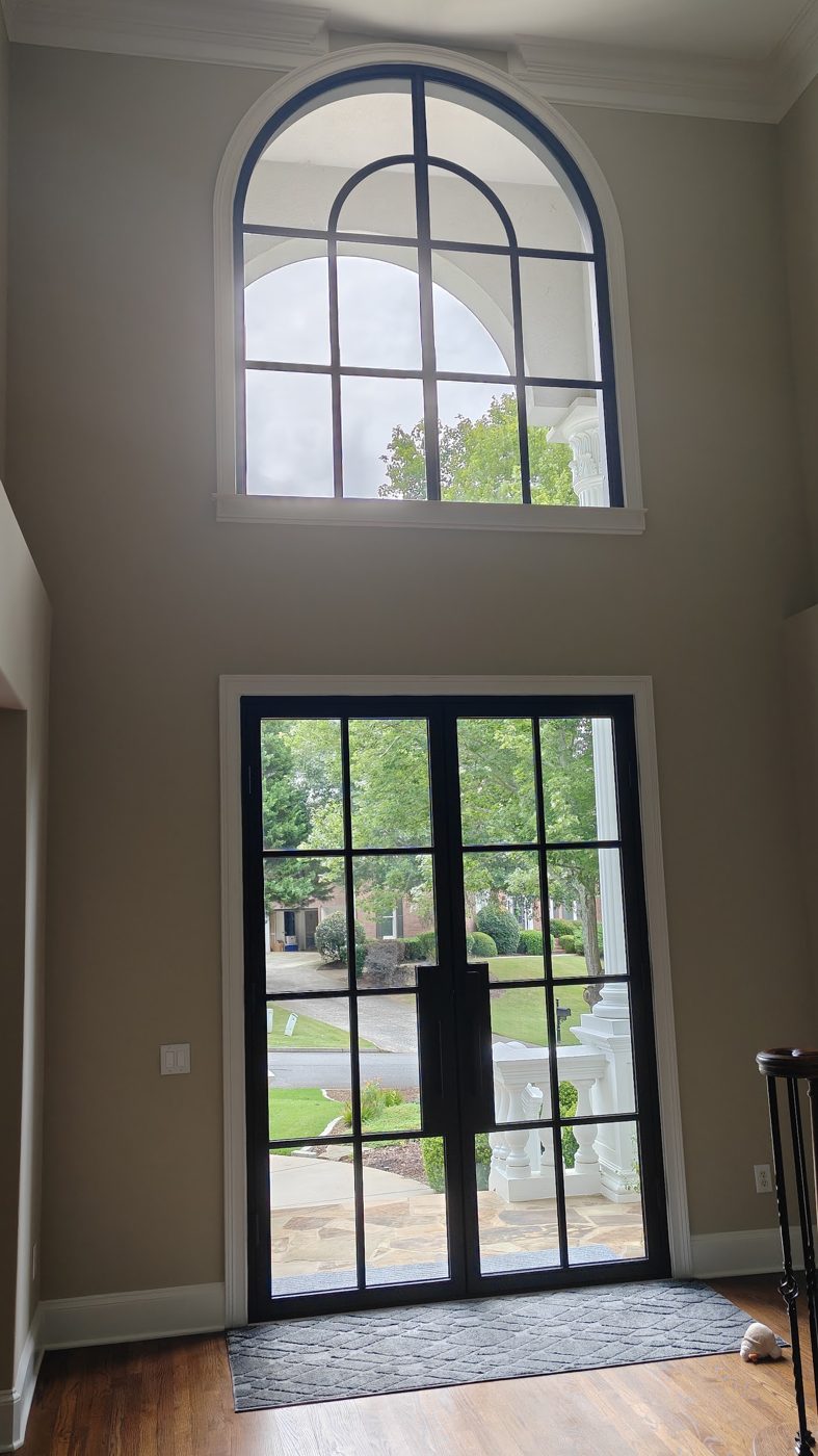Clean arched foyer window and front doors